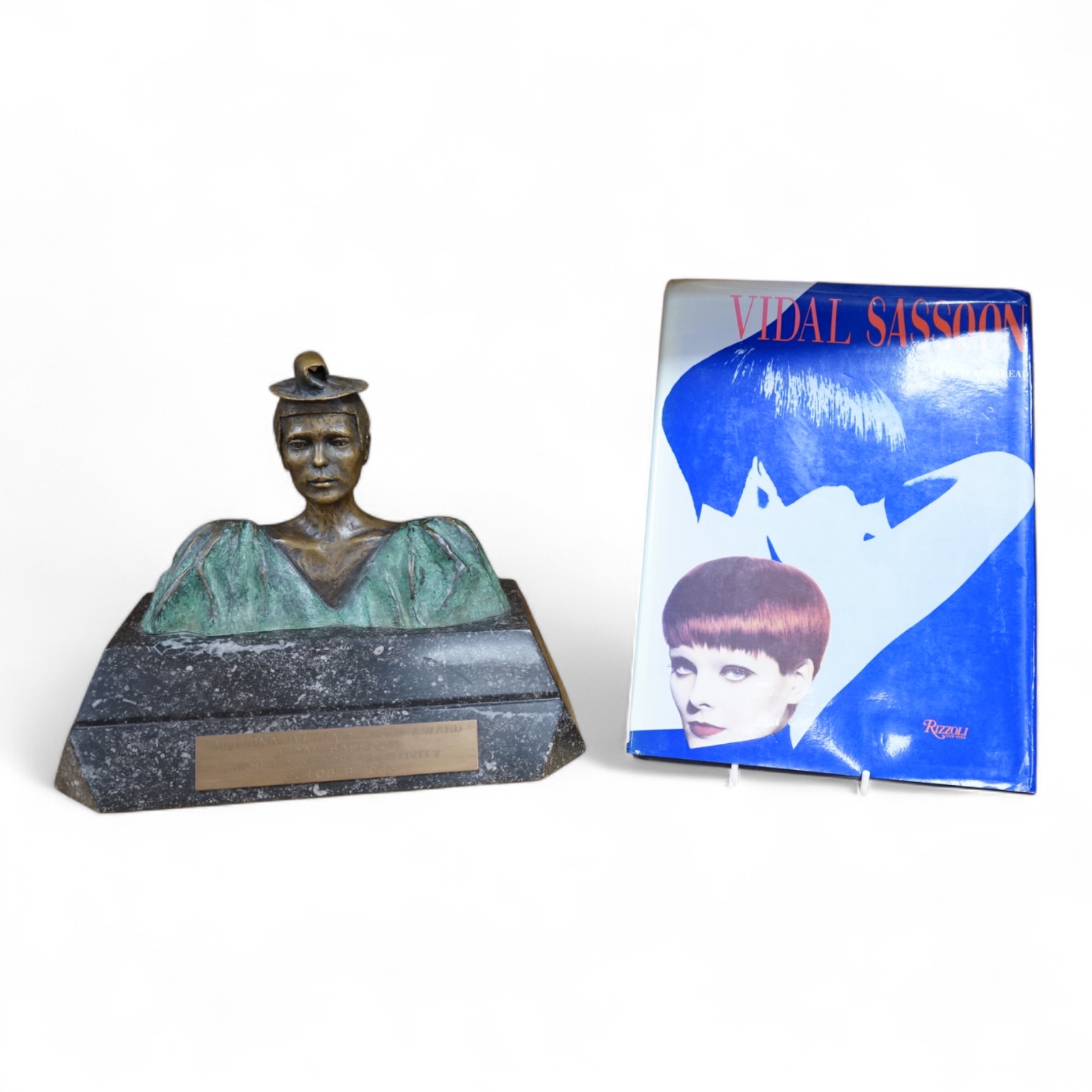 A figural bronze award: Alternative Hair Show Award Vidal Sassoon for 50 Years Creativity October 1993, together with Vidal Sassoon Fifty Years Ahead, a photographic history of his work. Award 29cm wide x 25cm high.